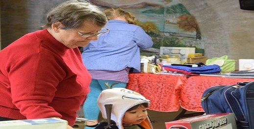 Volunteer helping a child select a Christmas present