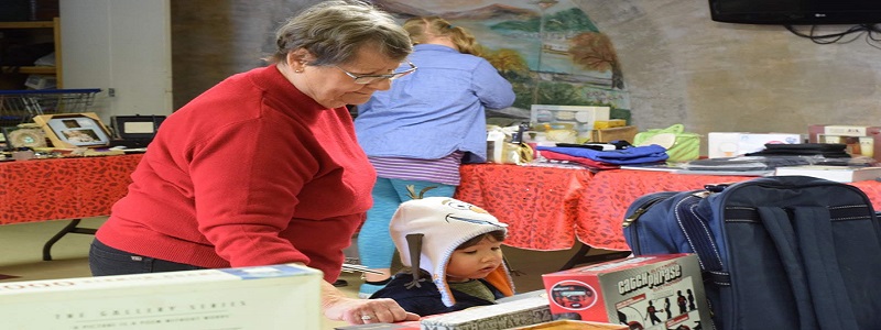 A volunteer helping a child select a Christmas present