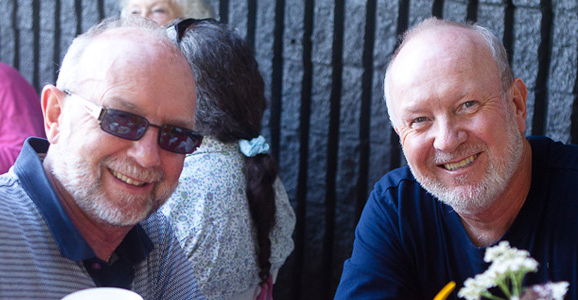 Two people smiling at the camera