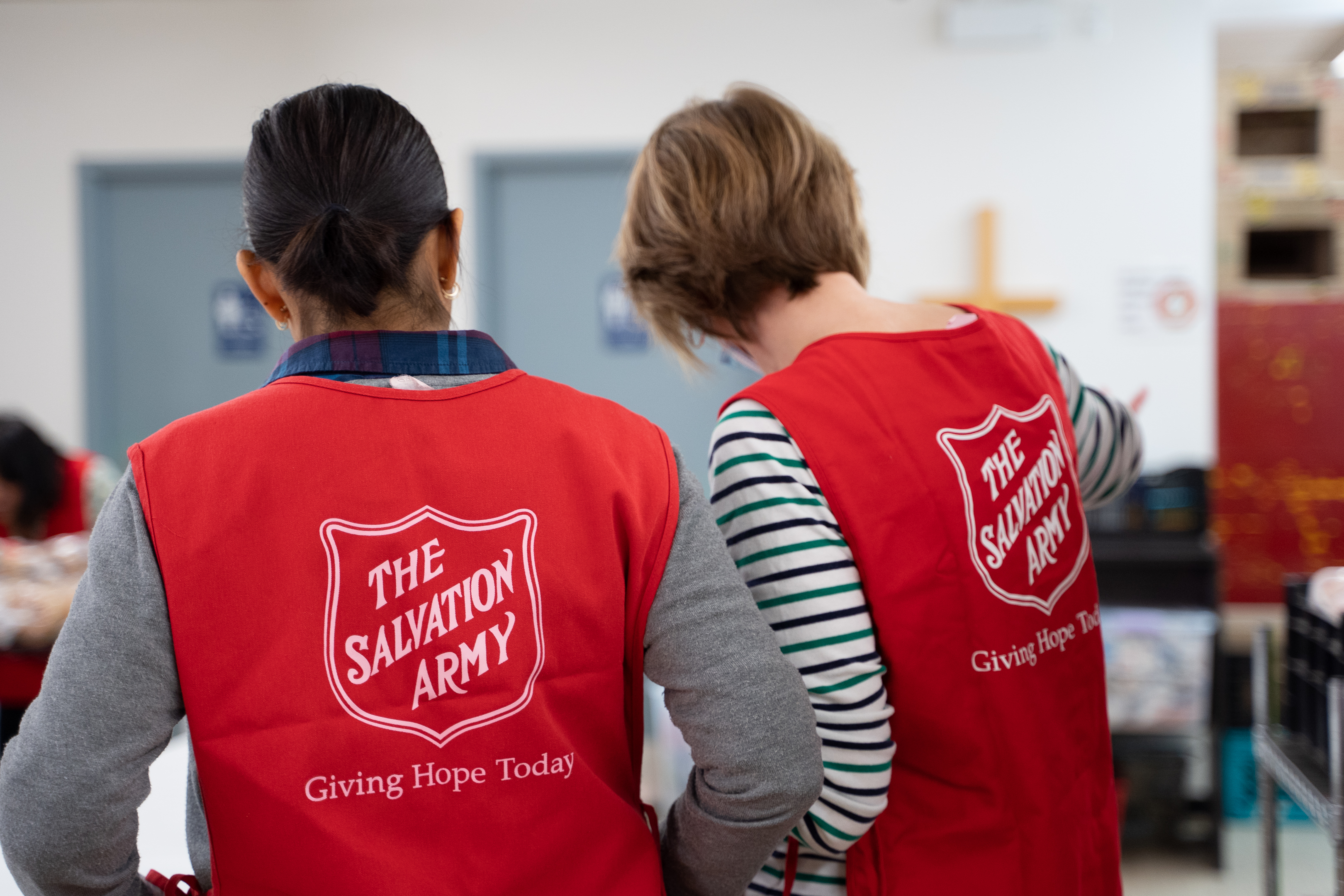 Two volunteers helping a Ministry unit for an upcoming event